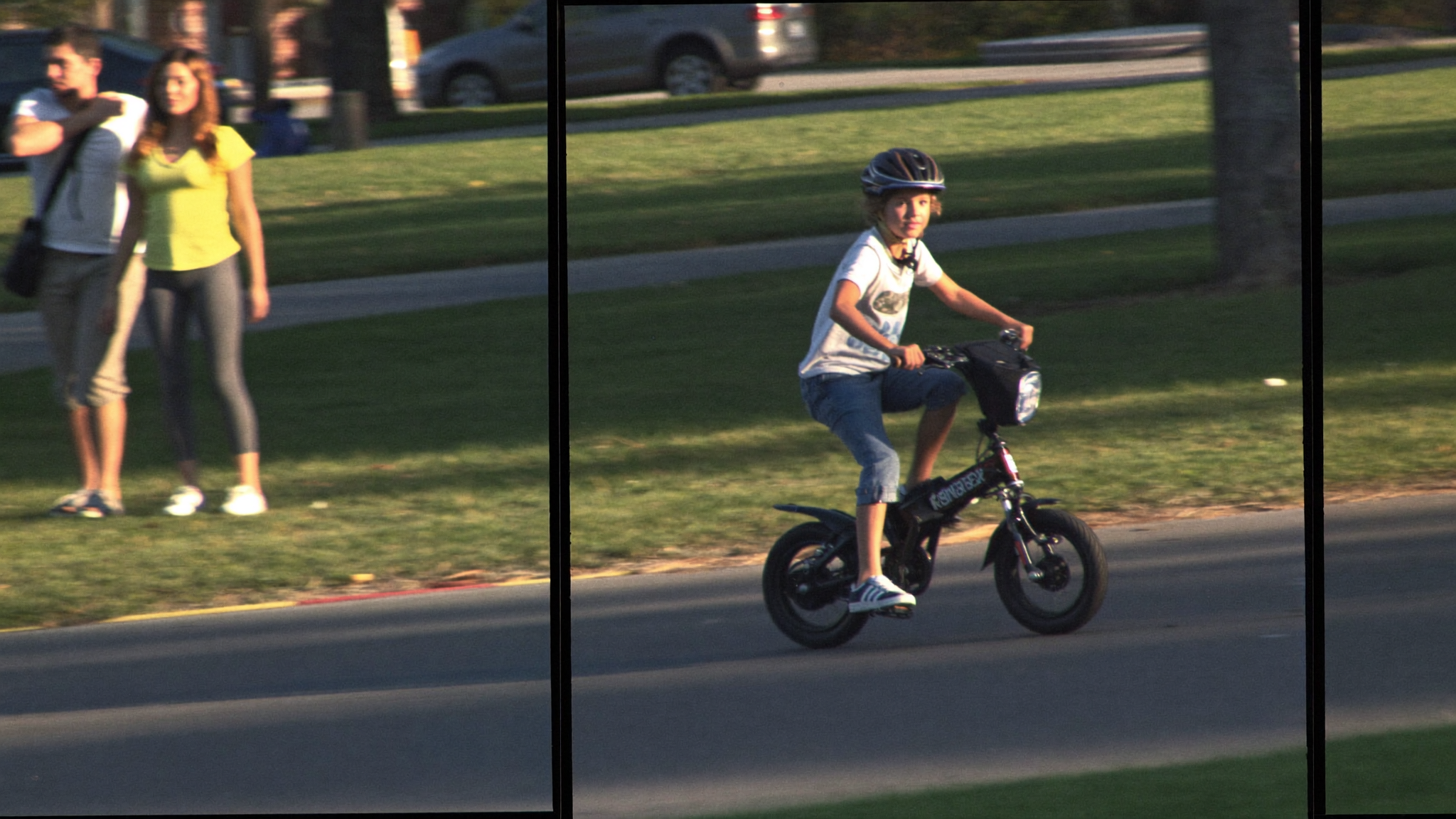 Preteen riding a small electric bike on a suburban path with a parent walking alongside