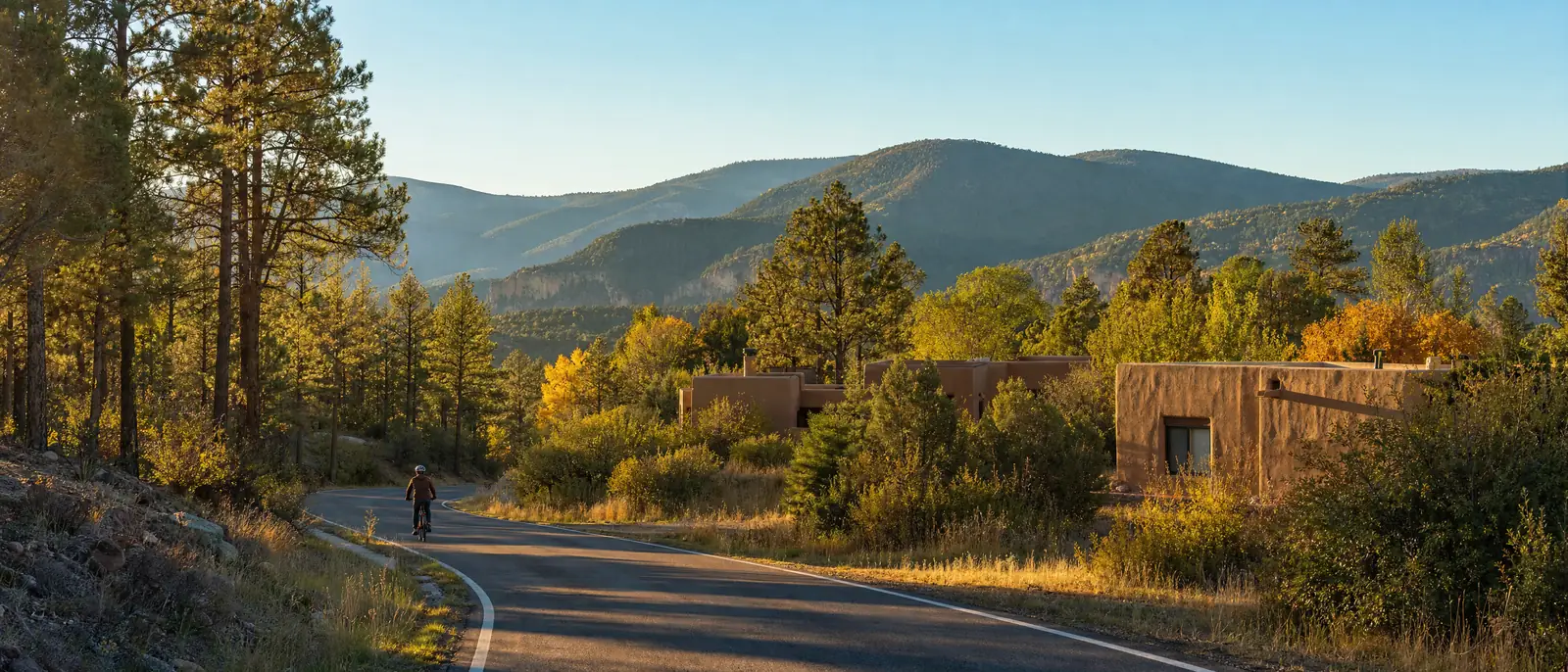 Illustration of an eBike rider on a mountain road through ponderosa pine and aspen with adobe buildings in the northern New Mexico mountains, in the style of the northern New Mexico mountains, NM