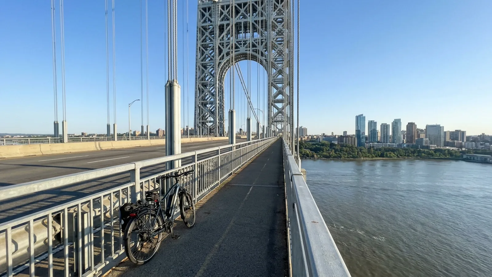 Electric bike on the pedestrian and bike path of a steel suspension bridge over the Hudson River at Fort Lee New Jersey
