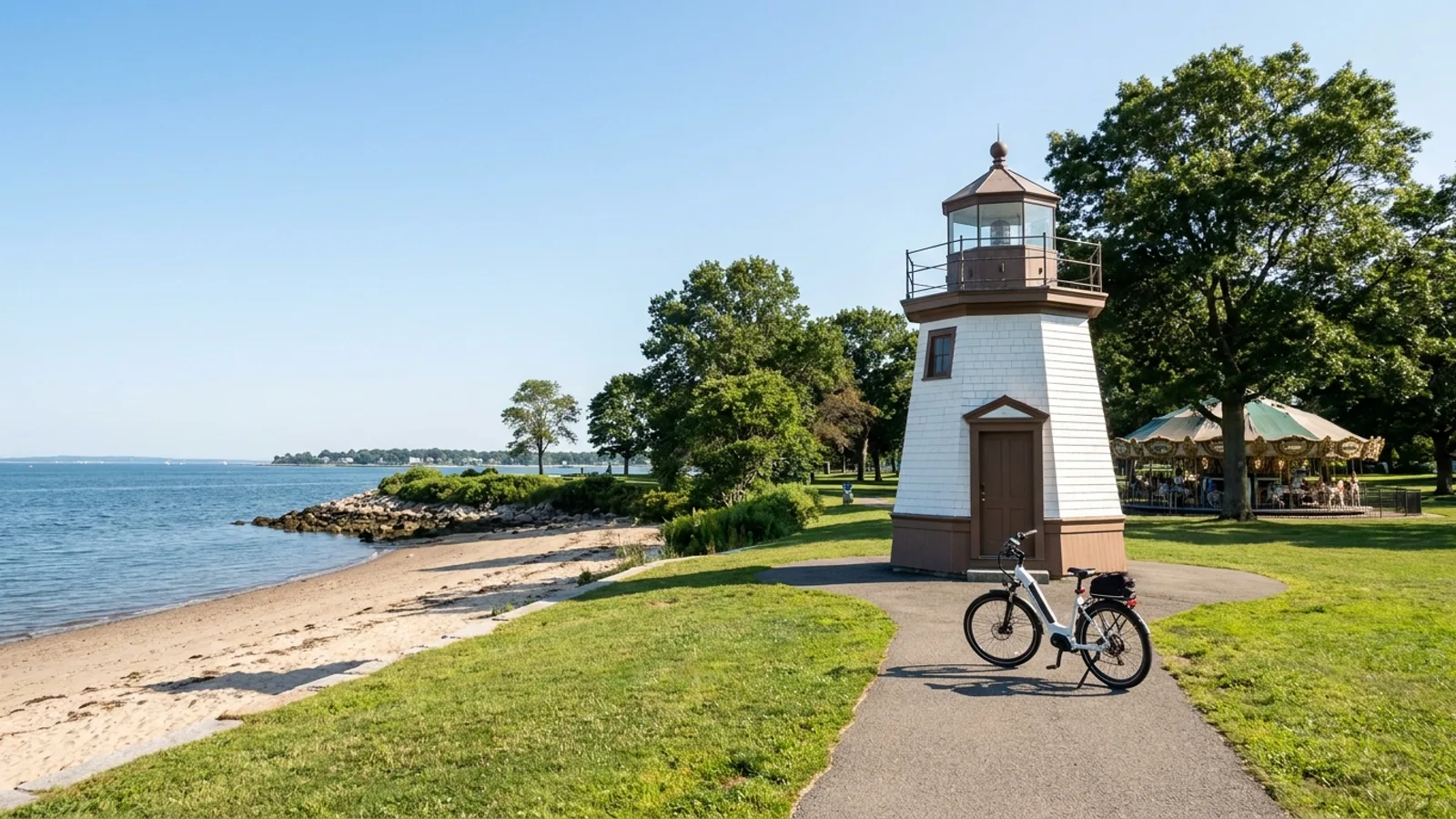 Electric bike on a paved park path near a historic lighthouse above a sandy beach on Long Island Sound