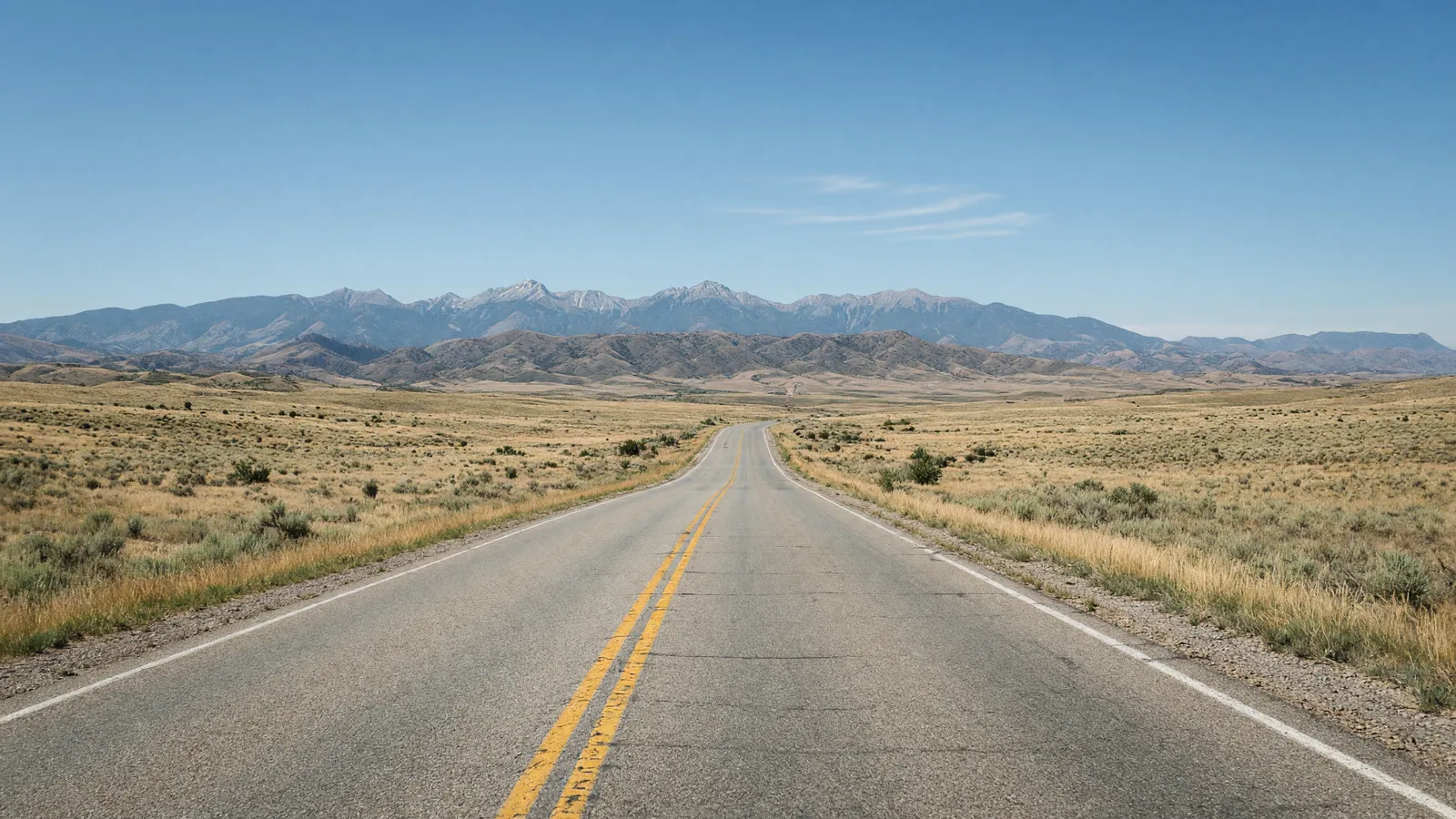 Empty high-plains two-lane toward the Sangre de Cristo foothills near Raton, Colfax County, New Mexico