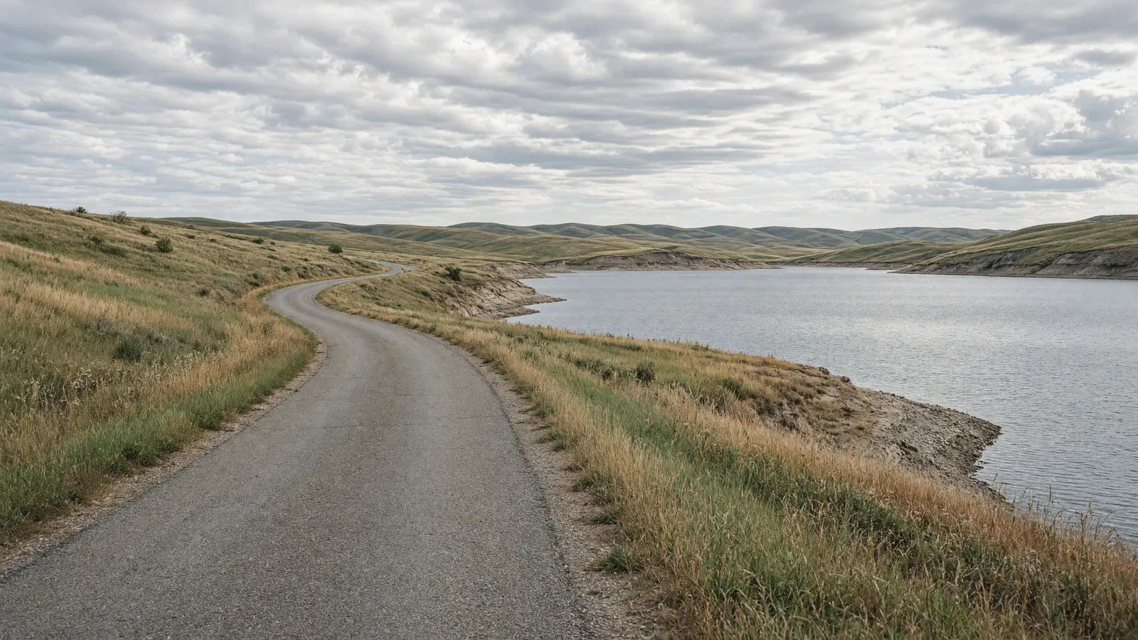Empty Lake Francis Case shoreline road through mixed-grass prairie near Platte, Charles Mix County, South Dakota