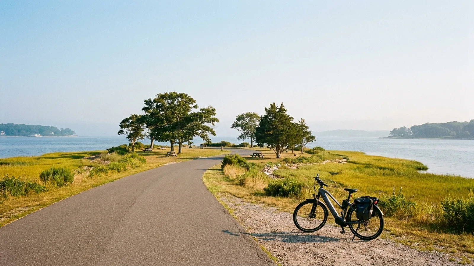 eBike on a paved park road across a low grassy peninsula between salt marsh and Long Island Sound in Connecticut